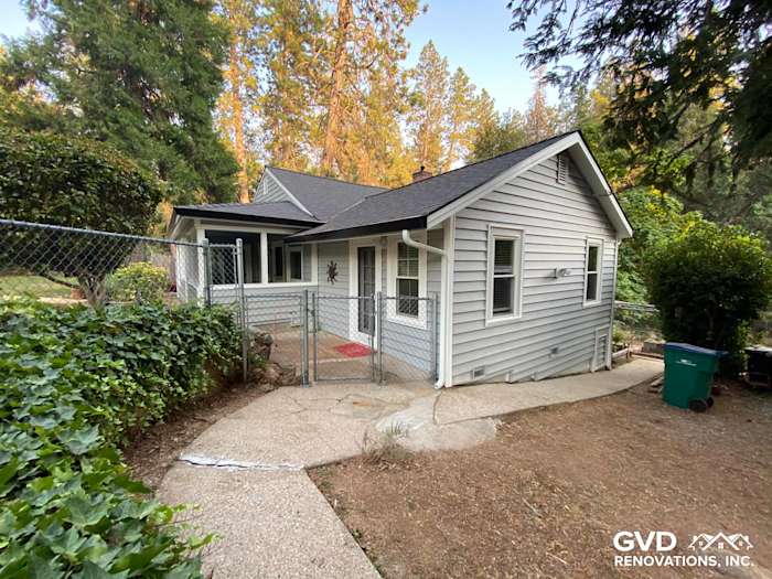 Updated home exterior featuring Alside Prodigy Vinyl Siding in light gray, surrounded by greenery in Grass Valley