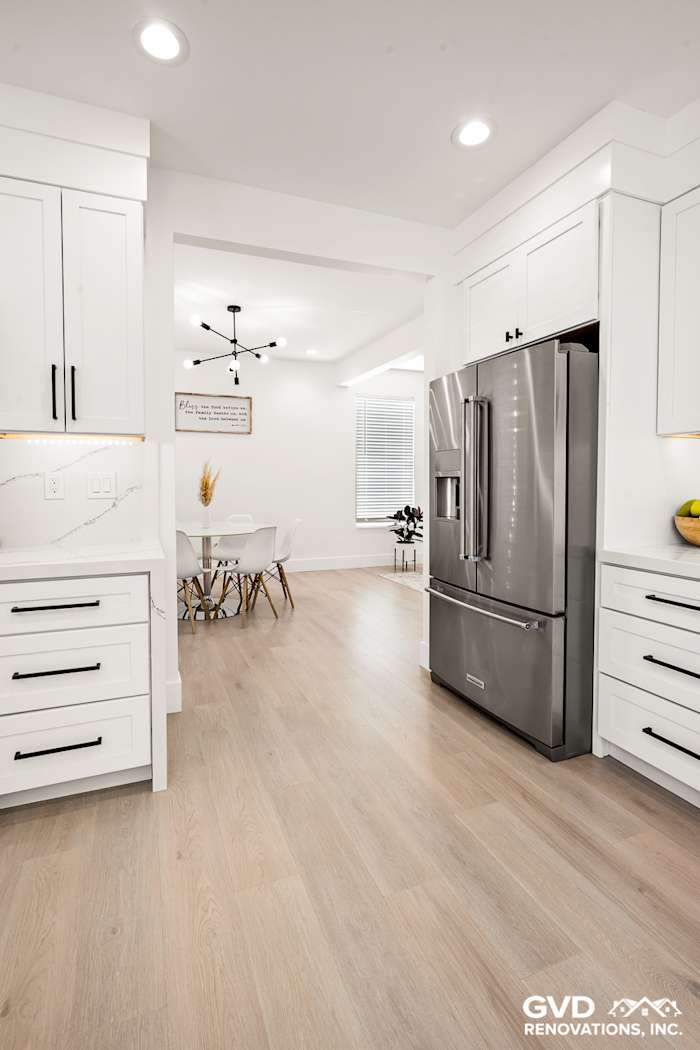 Elegant kitchen remodel featuring quartz countertops, custom cabinets, and a modern stainless steel refrigerator