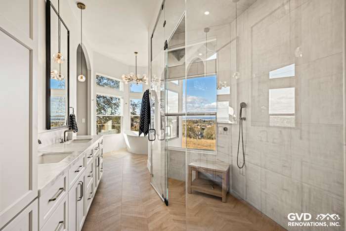Luxurious El Dorado Hills bathroom remodel featuring a zero-threshold steam shower, freestanding tub, and custom tilework