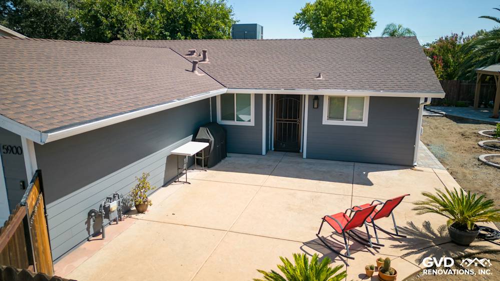 Home exterior featuring Night Gray James Hardie lap siding, Arctic White trim, and a patio area with furniture
