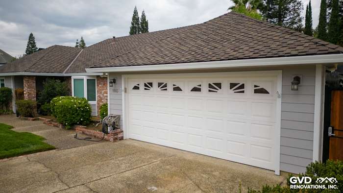 Freshly renovated home exterior featuring James Hardie Cedarmill siding, Milgard windows, and a stylish garage door