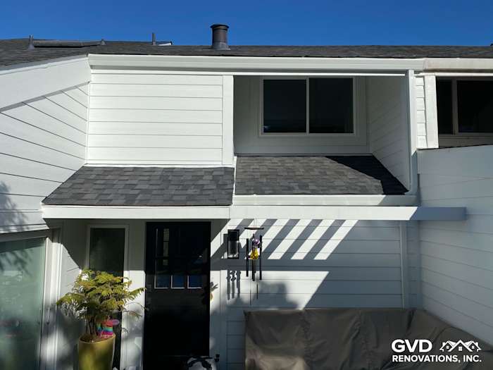Newly installed pre-finished James Hardie lap siding on home exterior with gray shingles in Mill Valley, CA