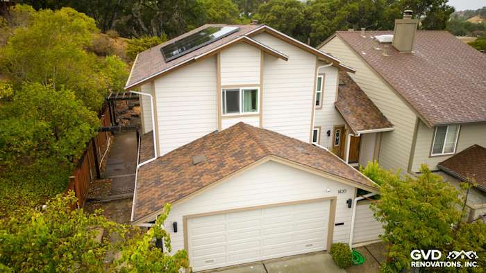 San Mateo home featuring new Khaki Brown HardiePlank siding and Rustic Grain trim under a cloudy sky