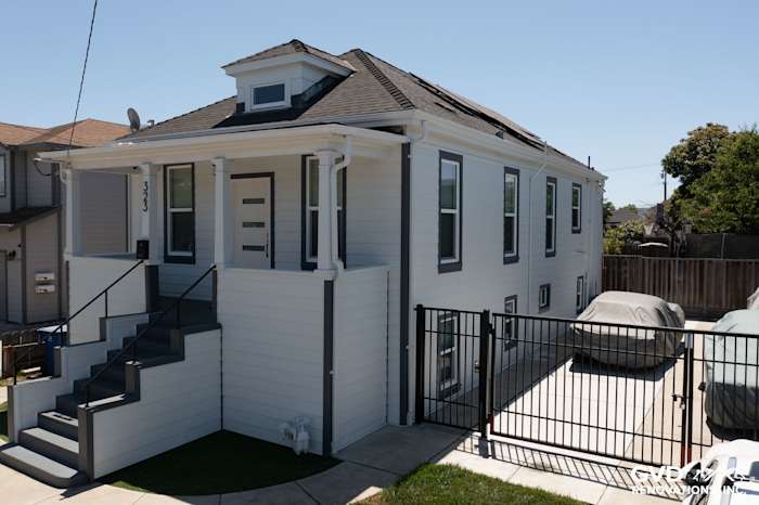 Arctic White James Hardie Color Plus Lap Siding on a modern San Leandro home exterior with stylish trim and stairs