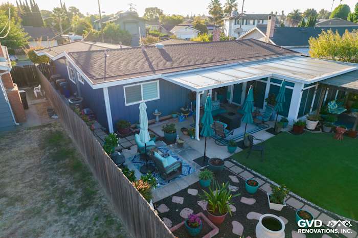 Backyard view of a home with Prodigy Vinyl Siding, featuring a patio, seating area, and landscaping in Antioch, CA