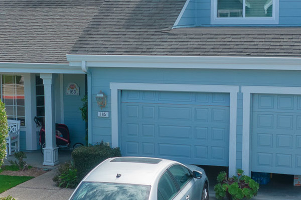 Transformed home exterior in Foster City with James Hardie siding and Alside windows, featuring blue trim and manicured
