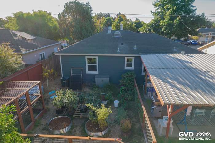 Backyard view of home with Evening Blue James Hardie siding and Arctic White trim in Concord, CA, featuring garden beds