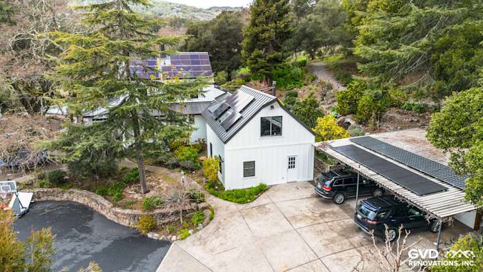 Updated home exterior featuring James Hardie Arctic White Siding and Marvin Windows in Sonoma, CA, surrounded by trees