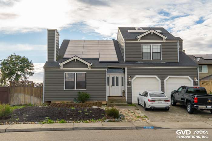 Two-story home exterior in Stockton with dark gray Prodigy Siding, modern roof, and solar panels