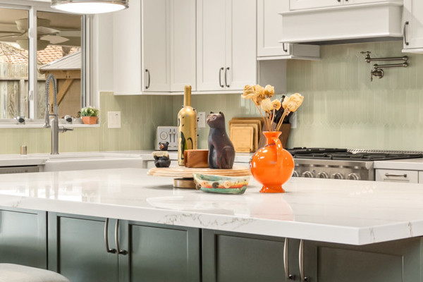 Modern kitchen remodel with custom island, sleek quartz countertops, and pendant lighting in warm colors