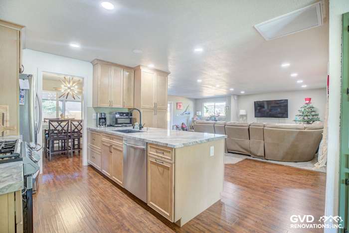 Modern kitchen remodel featuring light wood cabinetry, quartz countertops, and open floor plan in Sacramento