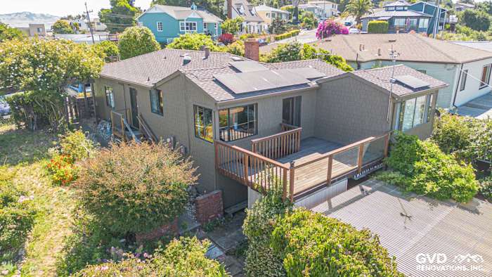 Home exterior in Vallejo featuring James Hardie Shake siding, custom paint, and solar panels on the roof