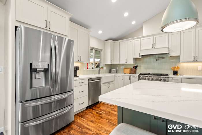Modern kitchen remodel in Carmichael featuring custom cabinets, sleek stainless steel appliances, and quartz island