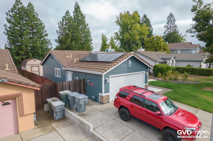 Exterior of a Rocklin home with James Hardie Evening Blue siding, Arctic White trim, and Eldorado Stone accents
