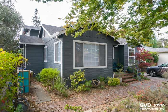 Freshly installed James Hardie Lap siding in dark gray on a Napa home with landscaped front yard