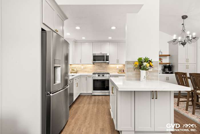 Modern kitchen in Roseville with Waypoint cabinetry, Vadara stone countertops, and MSI Brickstone Ivory backsplash