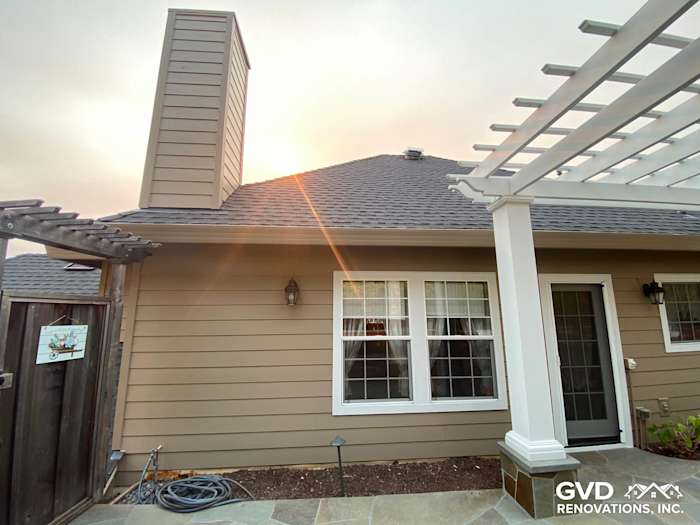 Khaki Brown James Hardie Lap Siding and Trim on a home with a chimney and pergola