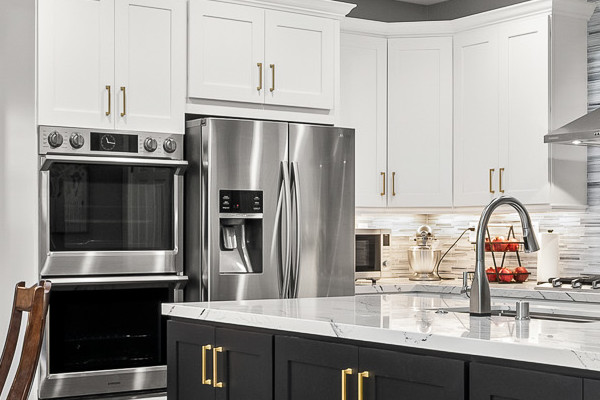 Modern kitchen remodel featuring Cambria countertops, custom cabinets, and light wood flooring in Roseville, CA