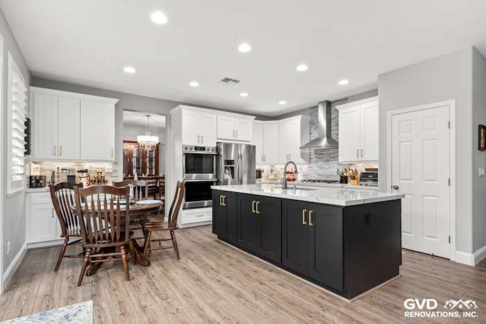 Modern kitchen remodel featuring Cambria countertops, custom cabinets, and light wood flooring in Roseville, CA