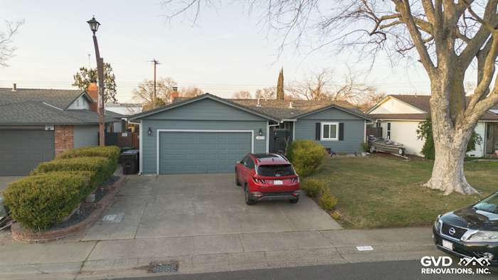 Home exterior in Rancho Cordova featuring Boothbay Blue James Hardie siding, painted eaves, and new gutters