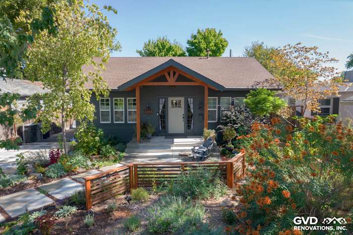 Home exterior showcasing James Hardie Iron Gray siding and contrasting trim, landscaped garden in Sacramento