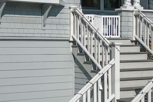 Two-story home in San Anselmo featuring Prime James Hardie Lap Siding in light blue, with white trim and railings