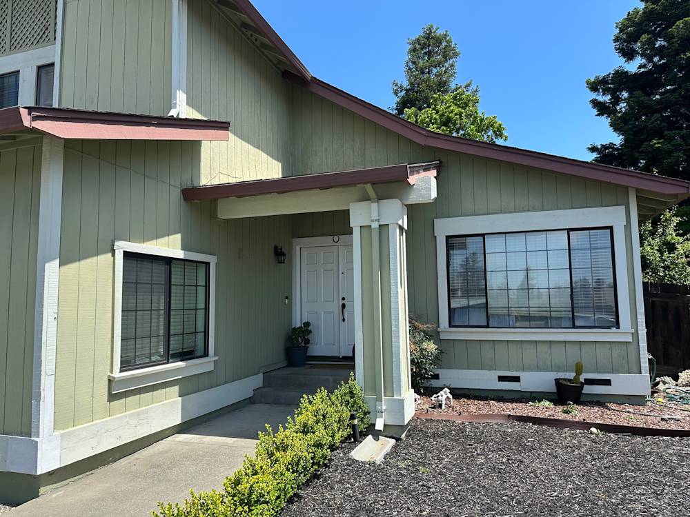 Light green exterior with a covered porch and large windows in Sacramento