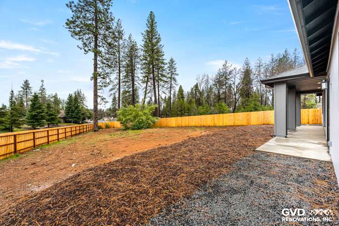 New construction home exterior in Paradise, CA, featuring a landscaped yard and wooden fence