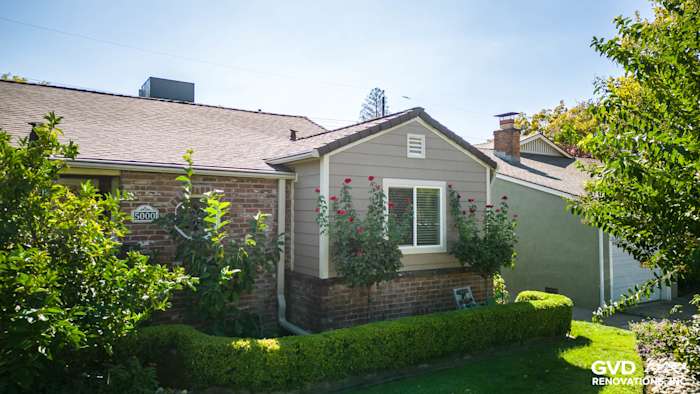 Modern Sacramento home featuring Khaki Brown James Hardie siding and flowering bushes in front garden