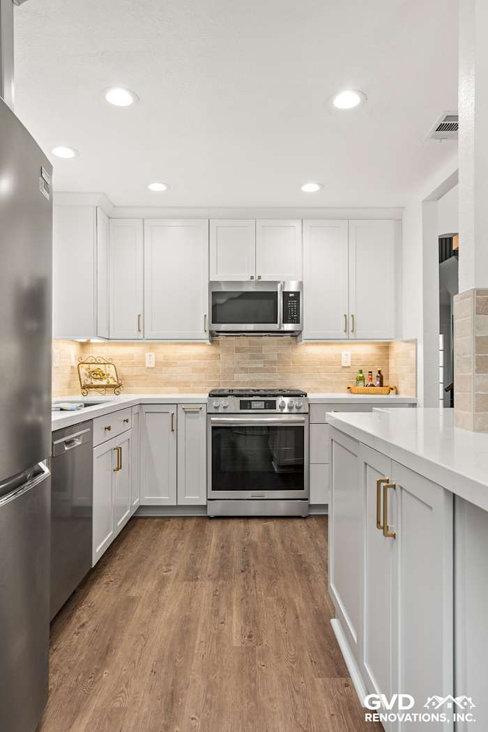 Modern kitchen remodel featuring Waypoint cabinetry, Vadara Naurelle countertops, and MSI Brickstone Ivory backsplash
