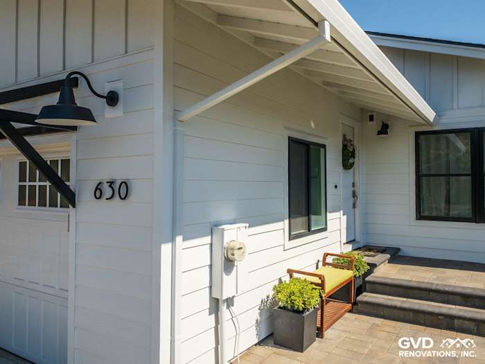 New James Hardie Board and Batten Siding on a modern home exterior with sleek entryway and planters