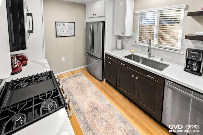 Modern kitchen remodel featuring dark cabinetry, stainless steel appliances, and a white quartz countertop in Davis, CA