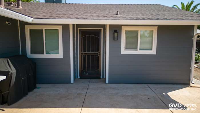 Home exterior showcasing James Hardie Night Gray siding and Arctic White trim with a welcoming entryway