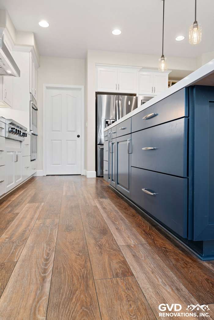 Modern kitchen with blue cabinetry, hardwood flooring, and stainless steel appliances in El Dorado Hills
