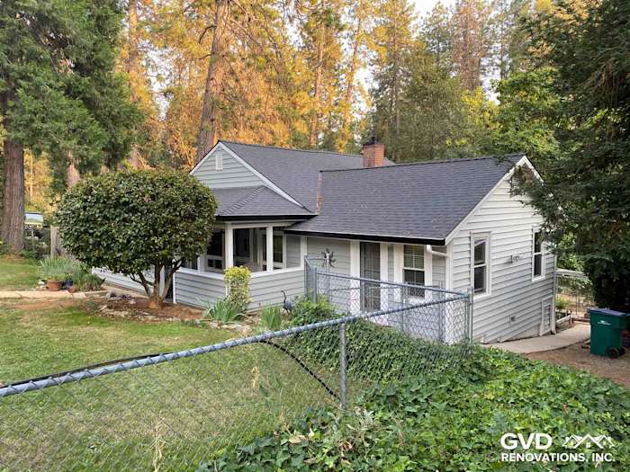 Updated home exterior featuring Prodigy Vinyl Siding in gray with gabled roof and landscaped yard in Grass Valley