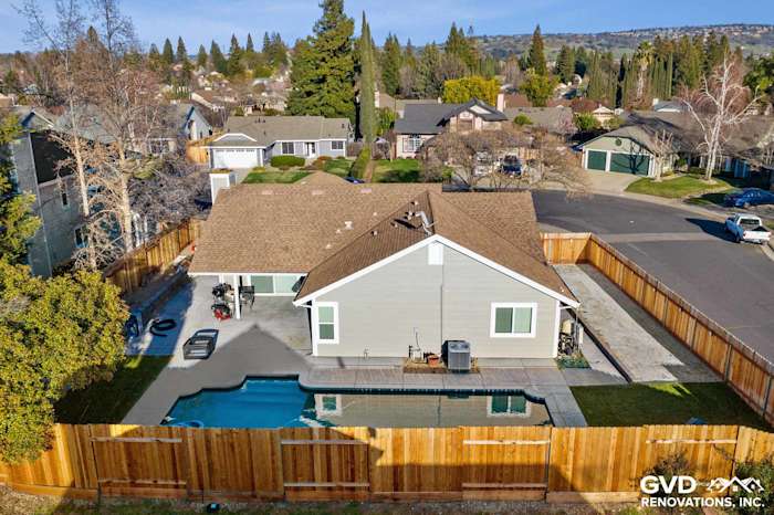Home exterior in Folsom, CA showcasing Monterey Taupe HardiePlank siding and Arctic White trim, with fenced backyard and pool