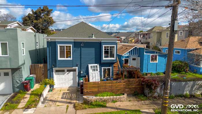 Two-story home in Oakland featuring new James Hardie Evening Blue siding and Arctic White trim, modern aesthetic