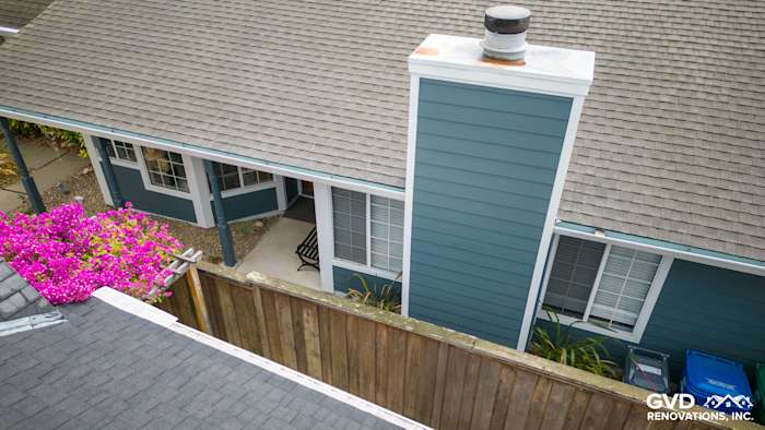 Evening Blue James Hardie siding with Arctic White trim and flower beds in Alameda home exterior
