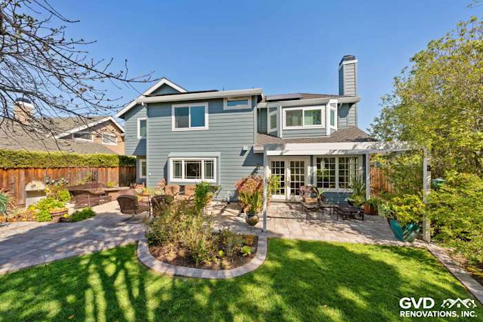 Two-story home exterior featuring Boothbay Blue HardiePlank siding, Arctic White trim, and landscaped patio in Foster City