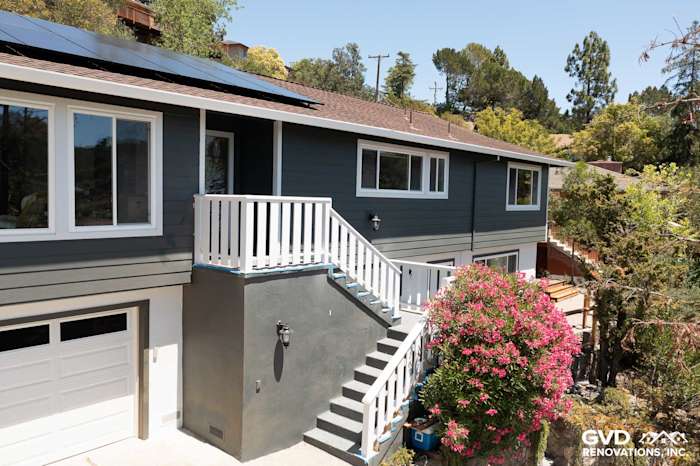 Home exterior in San Rafael featuring James Hardie Iron Gray siding and Arctic White trim with blooming flowers