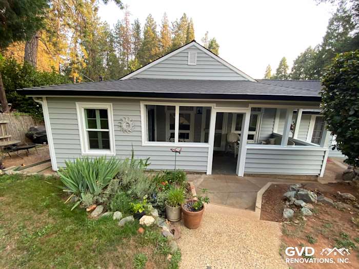 Light gray Prodigy Vinyl Siding on a ranch-style home with landscaped garden in Grass Valley, CA