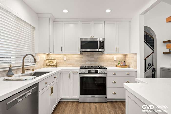 Modern kitchen in Roseville featuring Waypoint Painted Harbor cabinetry, Vadara Naurelle stone countertops, and MSI