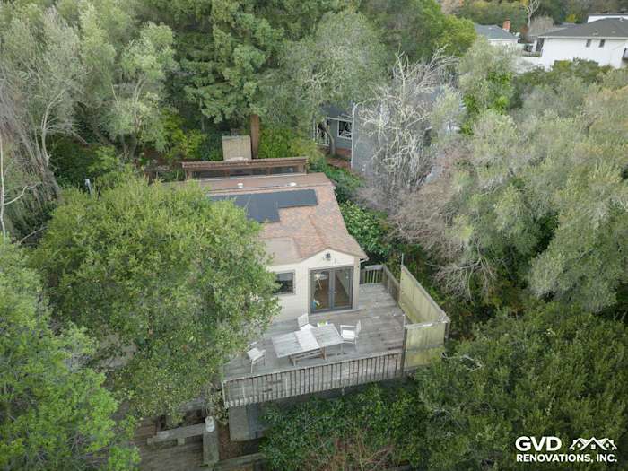 Home exterior in Oakland featuring James Hardie Khaki Brown siding and wooden deck surrounded by greenery