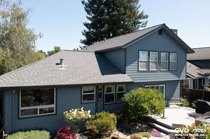 Rohnert Park home featuring new Boothbay Blue James Hardie siding and Milgard windows, surrounded by lush landscaping