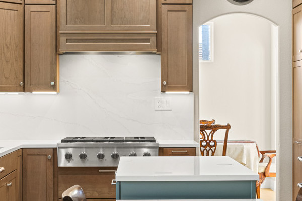 Bright kitchen featuring modern cabinetry, large central island, and quartz countertops in Davis renovation