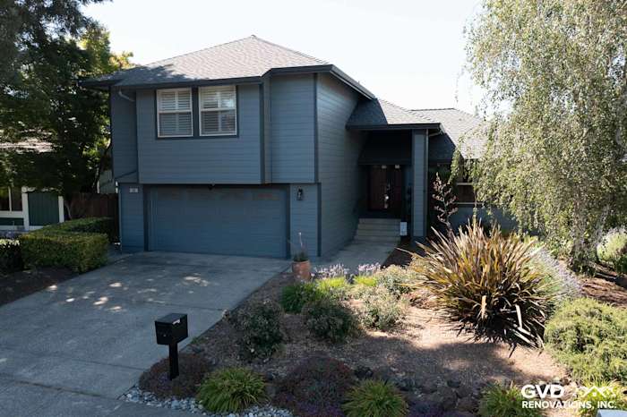 New home exterior featuring Boothbay Blue James Hardie siding, Milgard windows, and landscaped front yard in Rohnert Park