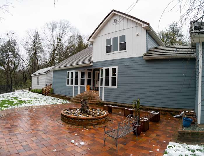 Sutter Creek home featuring Boothbay Blue James Hardie siding and new Milgard windows, with brick patio and fountain