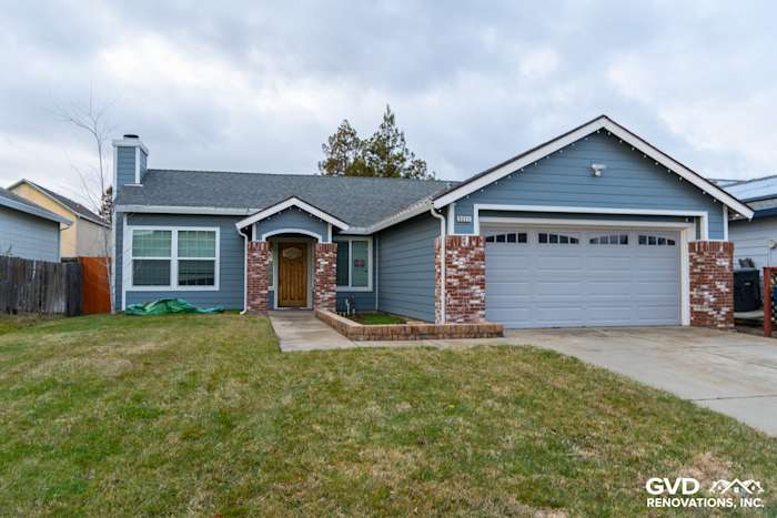 Home exterior featuring Boothbay Blue James Hardie siding, Arctic White trim, and brick accents in Sacramento