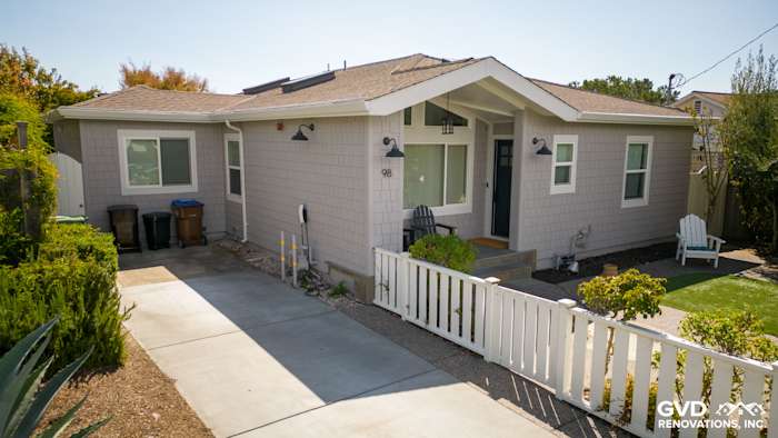 Pearl Gray James Hardie shingle siding with Arctic White trim on Mill Valley home exterior. Garden and driveway visible