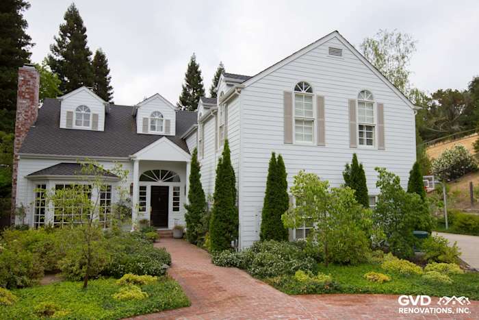 Orinda home with new Arctic White James Hardie siding, brick walkway, and lush landscaping